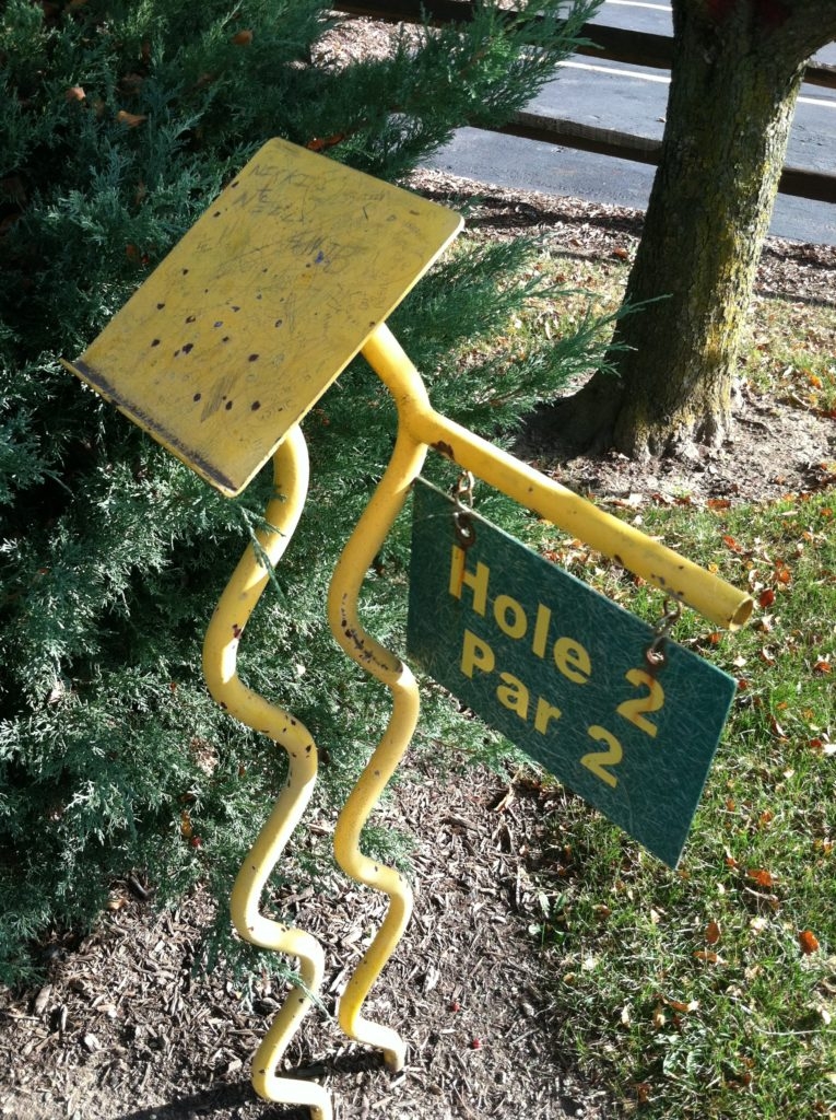 Scorecard stand and hole marker has seen better days